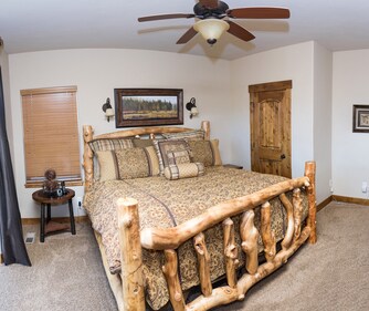 Bedroom with rustic log bed frame